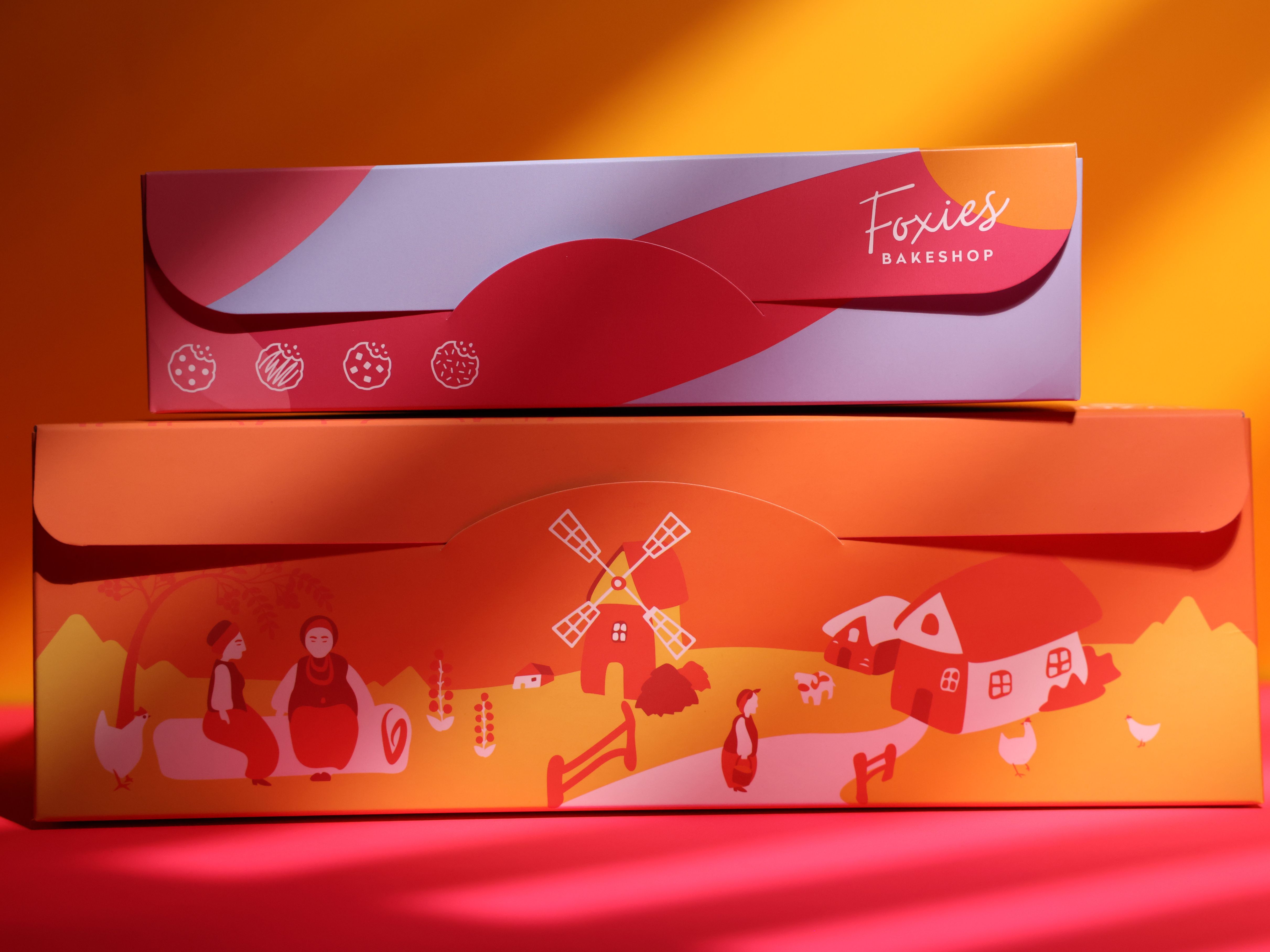 Two bakery boxes showcasing Pantone color usage and pattern design options.


